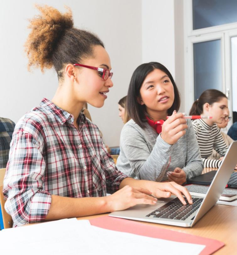 students studying in front of laptop